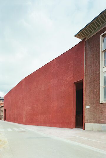 Wie die anderen Gebäude der Umgebung weist der Erweiterungsbau des Z33 in Hasselt, Belgien, zur Straße hin eine fast fensterlose Backsteinfassade auf, die an römisches opus reticolatum – eine rautenförmige Mauerverblendung – erinnert<br/><br/>Foto: Copyright Gion von Albertini<br/><br/>jpg, 3561 × 5315 Pixel